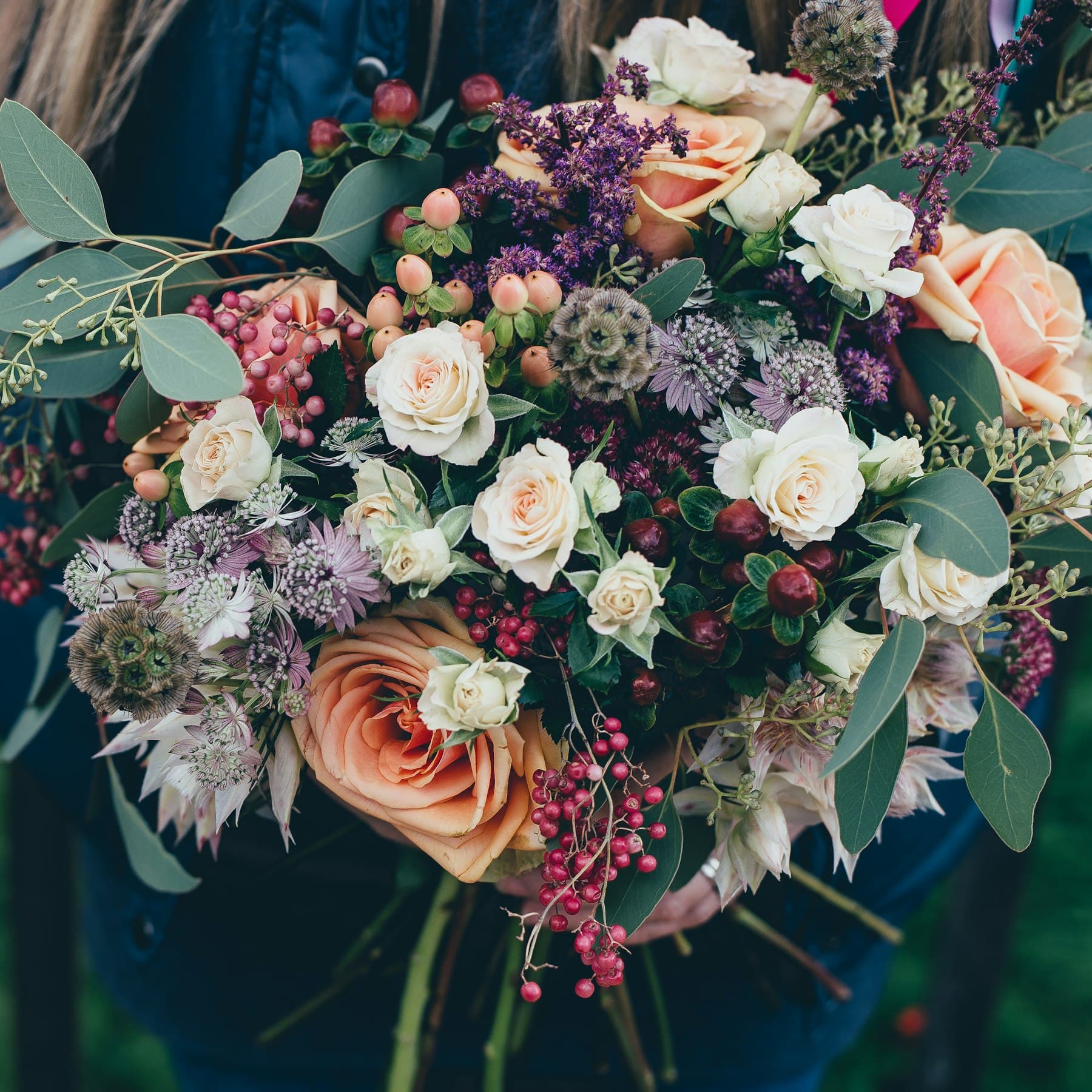 A soft muted botanical arrangement in warm natural light